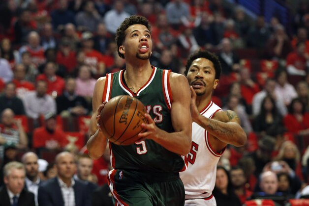 Apr 27, 2015; Chicago, IL, USA; Milwaukee Bucks guard Michael Carter-Williams (5) drives to the basket against Chicago Bulls guard Derrick Rose (1) in game five of the first round of the 2015 NBA Playoffs at United Center. Mandatory Credit: Kamil Krzaczynski-USA TODAY Sports
