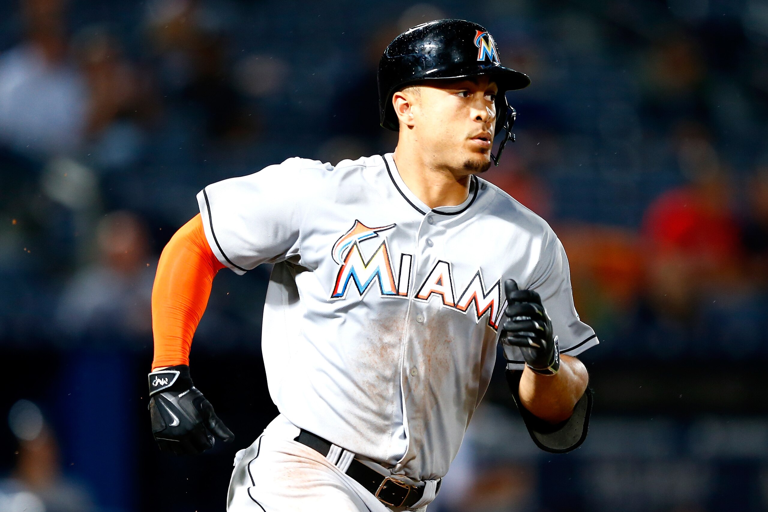 ATLANTA, GA - APRIL 14:  Giancarlo Stanton #27 of the Miami Marlins hits a RBI single in the fourth inning against the Atlanta Braves at Turner Field on April 14, 2015 in Atlanta, Georgia.  Dee Gordon #9 scored on the single.  (Photo by Kevin C. Cox/Getty Images)
