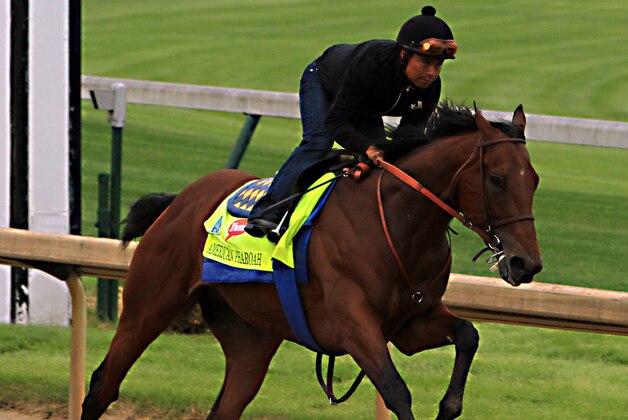 Martin Garcia rides Kentucky Derby hopeful American Pharoah during a morning workout at Churchill Downs in Louisville, Ky., Sunday, April 26, 2015. (AP Photo/Garry Jones)