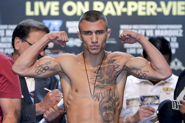 FILE - This Oct. 11, 2013 file photo shows Vasyl Lomachenko posing for photos in Las Vegas. Lomachenko attempted to win a world title in just his second pro bout, only to discover just how much he didn't know about prizefighting. Ukraine's two-time Olympic gold medalist will try for another championship belt Saturday in a compelling matchup with Gary Russell Jr., who thinks it's his own turn for long-awaited stardom. (AP Photo/Julie Jacobson, file)