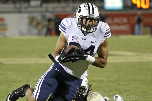 Brigham Young tight end Devin Mahina, left, slips past Central Florida defensive back Clayton Geathers, right, for a 15-yard touchdown during the second half of an NCAA college football game in Orlando, Fla., Thursday, Oct. 9, 2014. Central Florida won 31-24 in overtime. (AP Photo/John Raoux) Brigham Young tight end Devin Mahina, left, slips past Central Florida defensive back Clayton Geathers, right, for a 15-yard touchdown during the second half of an NCAA college football game in Orlando, Fla., Thursday, Oct. 9, 2014. Central Florida won 31-24 in overtime. (AP Photo/John Raoux)