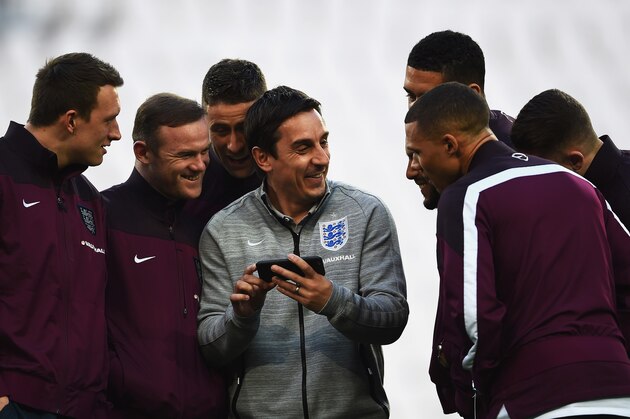TURIN, ITALY - MARCH 30:  First Team Coach Gary Neville of England laughs with England players including Phil Jones (L), Wayne Rooney (2ndL) and Gary Cahill (3rdL) during an England team stadium visit ahead of the International Friendly match against Italy at Juventus Arena on March 30, 2015 in Turin, Italy.  (Photo by Laurence Griffiths/Getty Images)