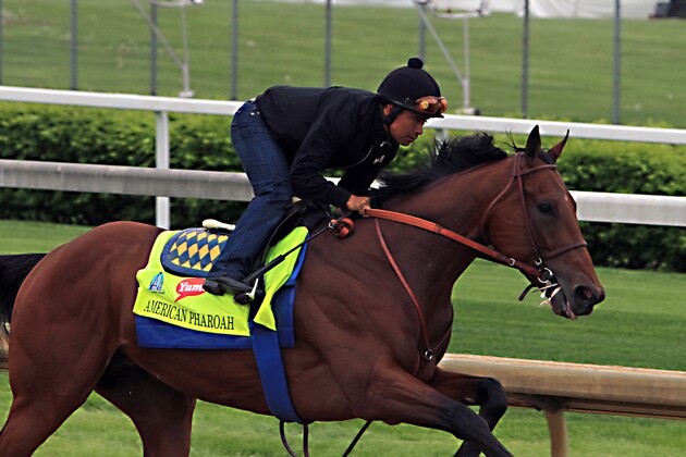 Martin Garcia rides Kentucky Derby hopeful American Pharoah during a morning workout at Churchill Downs in Louisville, Ky., Sunday, April 26, 2015. (AP Photo/Garry Jones)