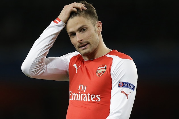 Arsenal's Olivier Giroud touches his head during the Champions League round of 16 soccer match between Arsenal and AS Monaco at the Emirates Stadium in London, Wednesday, Feb. 25, 2015.  (AP Photo/Matt Dunham)