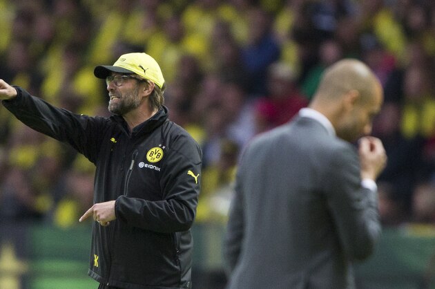 Dortmund head coach Juergen Klopp, left, gestures next to Bayern head coach Pep Guardiola of Spain during the German Soccer Cup Final between FC Bayern Munich and Borussia Dortmund at the Olympic Stadium in Berlin, Germany, Saturday, May 17, 2014. (AP Photo/Gero Breloer)