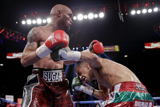 Ishe Smith, left, exchanges punches with Carlos Molina during an IBF junior middleweight title fight, Saturday, Sept. 14, 2013, in Las Vegas. (AP Photo/Eric Jamison)