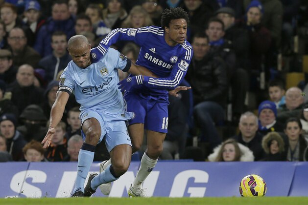 Chelsea’s Loic Remy, right, competes for the ball with Manchester City’s Vincent Kompany during the English Premier League soccer match between Chelsea and Manchester City at Stamford Bridge, London, Saturday, Jan. 31, 2015. (AP Photo/Tim Ireland)