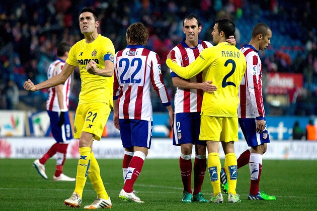 MADRID, SPAIN - DECEMBER 14:  Bruno Soriano (L) of Villarreal CF celebrates their victory as his teammate Mario Perez (2ndR) embares Diego Godin (3dR) of Atletico de Madrid after the La Liga match between Club Atletico de Madrid and Villarreal CF at Vicente Calderon Stadium on December 14, 2014 in Madrid, Spain.  (Photo by Gonzalo Arroyo Moreno/Getty Images)