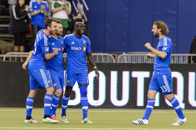 MONTREAL, QC - MARCH 28:  Jack McInerney #99 of Montreal Impact celebrates his goal with teammates during the MLS game against the Orlando City SC at the Olympic Stadium on March 28, 2015 in Montreal, Quebec, Canada.  (Photo by Minas Panagiotakis/Getty Images)