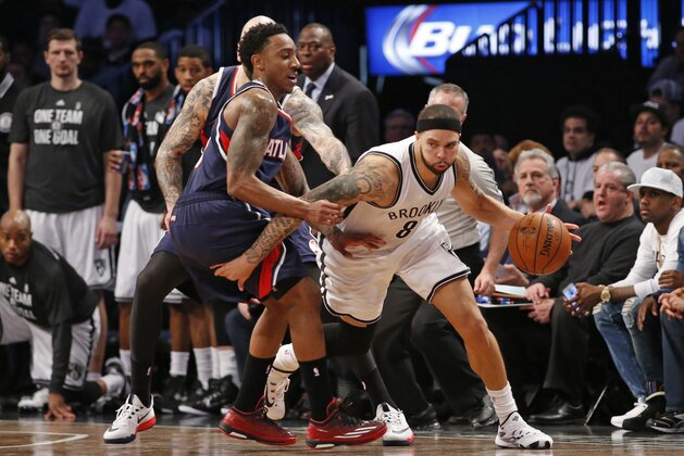 Atlanta Hawks guard Jeff Teague (0) defends Brooklyn Nets guard Deron Williams (8) in the second half of Game 4 of a first round NBA playoff basketball game, Monday, April 27, 2015, in New York. (AP Photo/Kathy Willens)