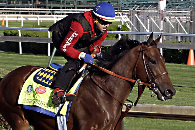 Kentucky Derby hopeful American Pharoah gallops under exercise rider Jorge Alvarez at Churchill Downs in Louisville, Ky., Thursday, April 23, 2015.  (AP Photo/Garry Jones)