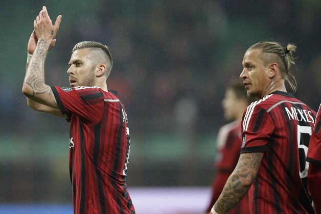 AC Milan's Jeremy Menez, left, celebrates as his teammate  AC Milan's Philippe Mexes looks him at the end of the Serie A soccer match between AC Milan and Cagliari at the San Siro stadium in Milan, Italy, Saturday, March 21, 2015. AC Milan won 3-1. (AP Photo/Antonio Calanni)