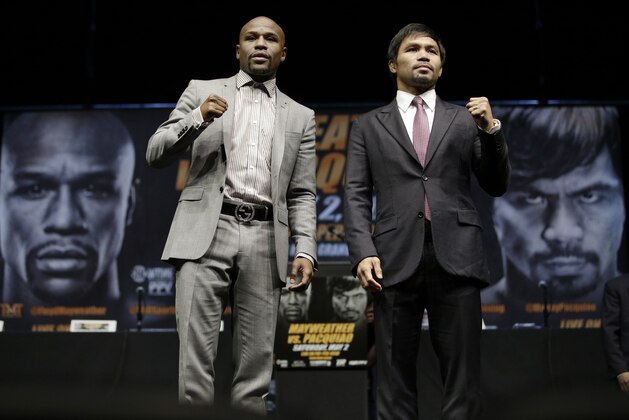 Floyd Mayweather Jr., left, and Manny Pacquiao, of the Philippines, pose for photos after a news conference, Wednesday, March 11, 2015, in Los Angeles. The two are scheduled to fight in Las Vegas on May 2. (AP Photo/Jae C. Hong)