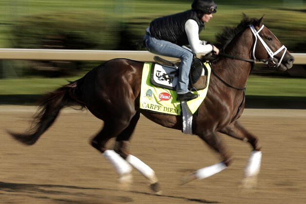 Kentucky Derby hopeful Carpe Diem is ridden by exercise rider Patti Krotenko during a morning workout at Churchill Downs Tuesday, April 28, 2015, in Louisville, Ky. (AP Photo/Charlie Riedel)