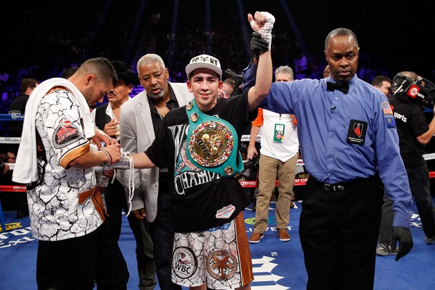 LAS VEGAS, NV - JANUARY 17:  WBC super bantamweight champion Leo Santa Cruz (C) poses with referee Kenny Bayless (R) after defeating Jesus Ruiz in a title fight at the MGM Grand Garden Arena on January 17, 2015 in Las Vegas, Nevada. Santa Cruz won with an eighth-round TKO. (Photo by Steve Marcus/Getty Images)