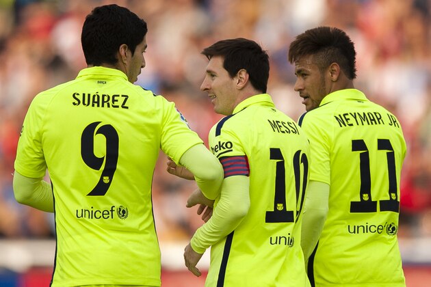 Barcelona's Lionel Messi, center, celebrates his goal with teammates Luis Suarez, left, and Neymar  during a Spanish La Liga soccer match between Granada and FC Barcelona at Los Carmenes stadium in Granada, Spain, Saturday Feb. 28, 2015. (AP Photo/Daniel Tejedor)