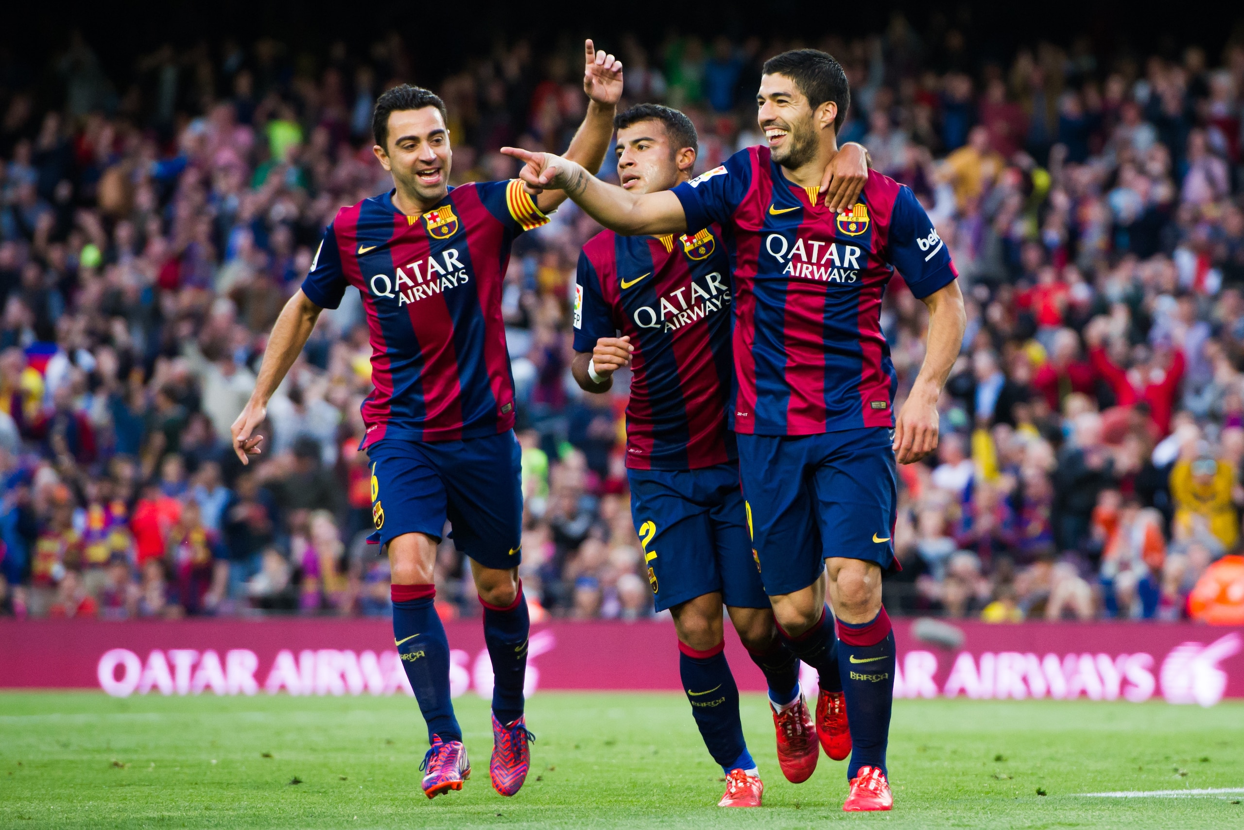 BARCELONA, SPAIN - APRIL 28: Luis Suarez (R) of FC Barcelona celebrates with his teammate Xavi Hernandez (L) and Rafinha (C) after scoring his team's second goal during the La Liga match between FC Barcelona and Getafe CF at Camp Nou on April 28, 2015 in Barcelona, Spain. (Photo by Alex Caparros/Getty Images)
