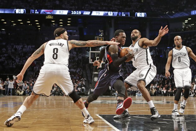 Brooklyn Nets guard Deron Williams (8)  and Nets guard Alan Anderson (6) defend a driving Atlanta Hawks guard Dennis Schroder (17) in the second half of Game 4 of a first round NBA playoff basketball game, Monday, April 27, 2015, in New York. The Nets defeated the Hawks 120-115 in overtime to even their series at 2-2. Nets guard Jarrett Jack (0) watches, far right. (AP Photo/Kathy Willens)