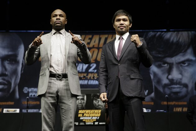 Floyd Mayweather Jr., left, and Manny Pacquiao, of the Philippines, pose for photos after a news conference, Wednesday, March 11, 2015, in Los Angeles. The two are scheduled to fight in Las Vegas on May 2. (AP Photo/Jae C. Hong)