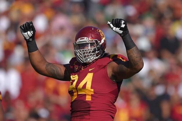 Southern California defensive end Leonard Williams gestures to fans during the first half an NCAA college football game against Notre Dame, Saturday, Nov. 29, 2014, in Los Angeles. Southern California won 49-14. (AP Photo/Mark J. Terrill)
