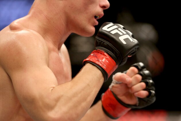 A closeup of the UFC logo on a fighter's gloves at UFC Fight Night Boston, Sunday, January 18, 2015 in Boston.  (AP Photo/Gregory Payan)