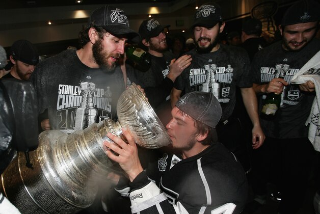 FILE - In this June 11, 2012, file photo, Los Angeles Kings' Mike Richards, Andrei Loktionov, Jonathan Quick and Drew Doughty celebrate with the Stanley Cup in the locker room after the Kings defeated the New Jersey Devils in game six of the NHL hockey Stanley Cup finals in Los Angeles. The Kings released Richards on Monday, Jan. 26, 2015, finally shaking up their relationship with the veteran center who has lost his scoring touch. (AP Photo/Dave Sandford, Pool, File)