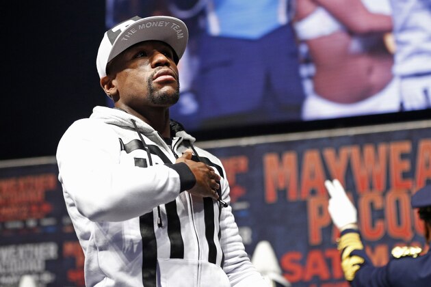 Boxer Floyd Mayweather Jr. motions to the crowd during an arrival ceremony Tuesday, April 28, 2015, in Las Vegas. Mayweather will face Manny Pacquiao in a welterweight boxing match in Las Vegas on May 2. (AP Photo/John Locher) Boxer Floyd Mayweather Jr. motions to the crowd during an arrival ceremony Tuesday, April 28, 2015, in Las Vegas. Mayweather will face Manny Pacquiao in a welterweight boxing match in Las Vegas on May 2. (AP Photo/John Locher)