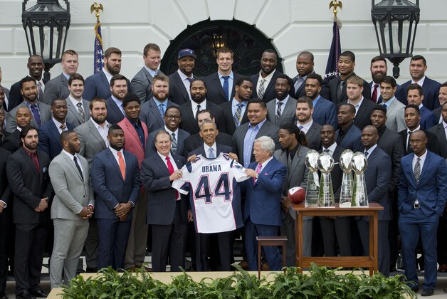 President Barack Obama holds a New England Patriots team jersey, flanked by New England Patriots coach Bill Belichick, left, and team owner Robert Kraft, right, as he welcomed the Super Bowl Champion New England Patriots, Thursday, April 23, 2015, on the South Lawn of the White House in Washington, to honor the team and their Super Bowl XLIX victory. (AP Photo/Pablo Martinez Monsivais)