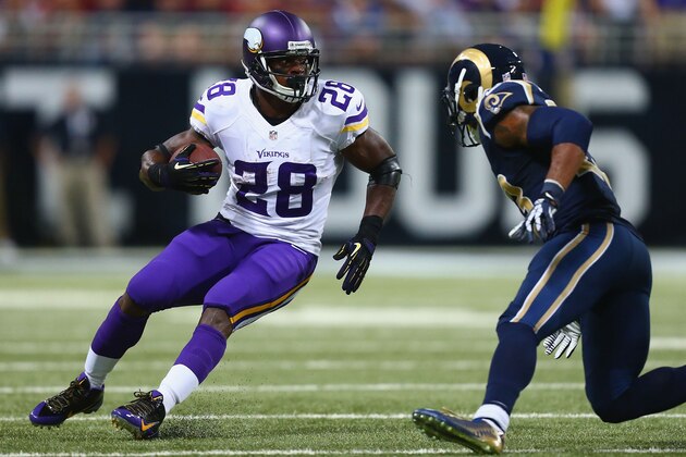 ST. LOUIS, MO - SEPTEMBER 7: Adrian Peterson #28 of the Minnesota Vikings looks to get past a member of the St. Louis Rams defense at the Edward Jones Dome on September 7, 2014 in St. Louis, Missouri.  (Photo by Dilip Vishwanat/Getty Images)