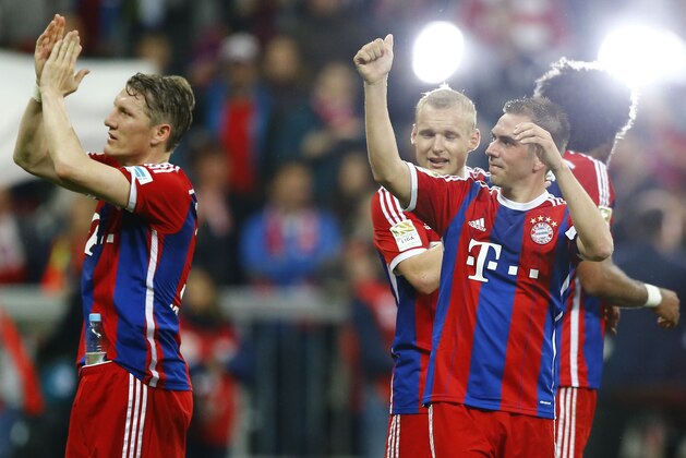 Bayern's Bastian Schweinsteiger, left, and Philipp Lahm celebrate after the German first division Bundesliga soccer match between FC Bayern Munich and Hertha BSC at the Allianz Arena in Munich, Germany, on Saturday, April 25, 2015. (AP Photo/Matthias Schrader)