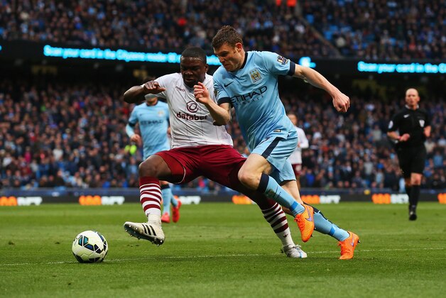 MANCHESTER, ENGLAND - APRIL 25: James Milner of Manchester City takes on Jores Okore of Aston Villa during the Barclays Premier League match between Manchester City and Aston Villa at Etihad Stadium on April 25, 2015 in Manchester, England.  (Photo by Alex Livesey/Getty Images)