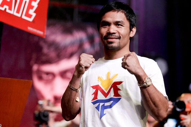 Boxer Manny Pacquiao, of the Philippines, poses for fans at a rally in Las Vegas, Tuesday, April 28, 2015. Floyd Mayweather Jr. and Manny Pacquiao are scheduled to fight May 2. (AP Photo/Chris Carlson)