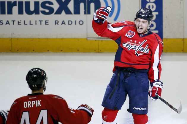 Washington Capitals center Evgeny Kuznetsov, right, from Russia, celebrates his game winning goal with defenseman Brooks Orpik (44) during the third period of Game 7 in the first round of the NHL hockey Stanley Cup playoffs against the New York Islanders, Monday, April 27, 2015, in Washington. The Capitals won 2-1, to advance. (AP Photo/Alex Brandon)