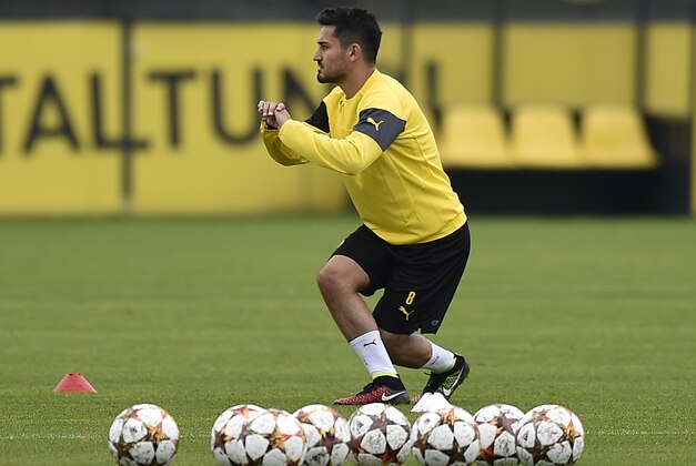Borussia Dortmund's Ilkay Gundogan exercises during a training session in Dortmund, Germany, Monday, Sept. 15, 2014. Dortmund will play Arsenal in a Champions League Group D soccer match on Tuesday. (AP Photo/Martin Meissner)