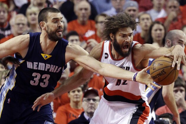 Portland Trail Blazers center Robin Lopez, right, battles for the ball with Memphis Grizzlies center Marc Gasol, from Spain during the first half of Game 4 of a first-round NBA basketball playoff series in Portland, Ore., Monday, April 27, 2015.  (AP Photo/Don Ryan)