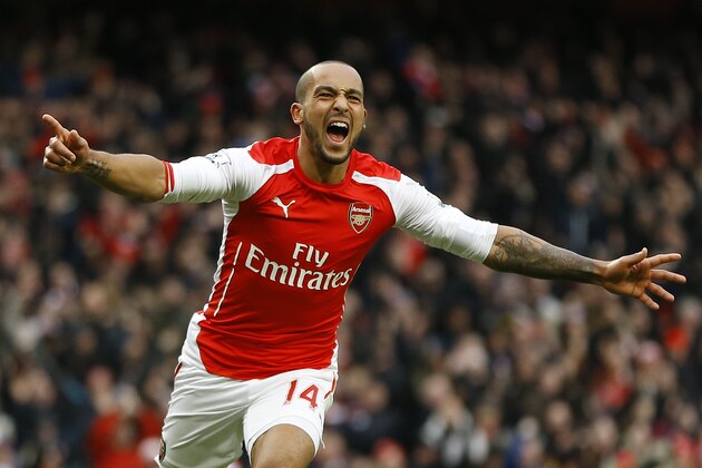 Arsenal's Theo Walcott celebrates scoring a goal during the English Premier League soccer match between Arsenal and Aston Villa at the Emirates stadium in London, Sunday, Feb. 1, 2015. (AP Photo/Kirsty Wigglesworth)