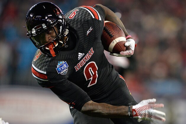 CHARLOTTE, NC - DECEMBER 30:  DeVante Parker #9 of the Louisville Cardinals makes a catch against Jordan Jenkins #59 of the Georgia Bulldogs during the Belk Bowl at Bank of America Stadium on December 30, 2014 in Charlotte, North Carolina. Georgia won 37-14.  (Photo by Grant Halverson/Getty Images)
