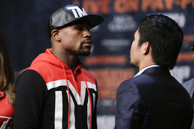 Boxers Floyd Mayweather Jr., left, and Manny Pacquiao pose for photographers during a press conference Wednesday, April 29, 2015, in Las Vegas. The pair are slated to square off Saturday in Las Vegas.  (AP Photo/Chris Carlson)