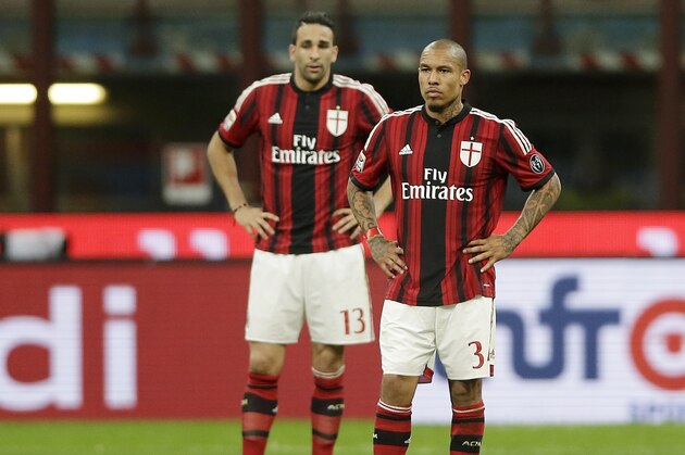 AC Milan's Nigel de Jong, right, and Adil Rami stand on the pitch after Genoa’s Alberto Costa scored during the Serie A soccer match between AC Milan and Genoa at the San Siro stadium in Milan, Italy, Wednesday, April 29, 2015. (AP Photo/Antonio Calanni)