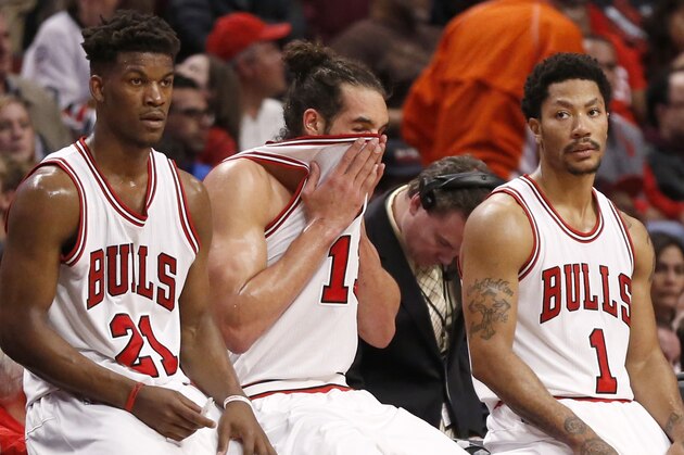 Chicago Bulls' players from left, Jimmy Butler, Joakim Noah, and Derrick Rose, wait for play to resume during the second half in Game 5 of the NBA basketball playoffs against the Milwaukee Bucks Monday, April 27, 2015, in Chicago. The Bucks won 94-88. (AP Photo/Charles Rex Arbogast)