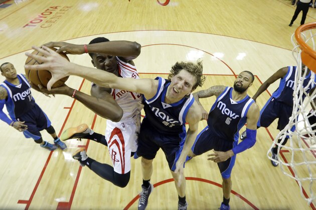 Houston Rockets' Clint Capela (15) puts up a shot against Dallas Mavericks' Dirk Nowitzki (41) during the first half of Game 5 in the first round of the NBA basketball playoffs Tuesday, April 28, 2015, in Houston. (AP Photo/David J. Phillip)