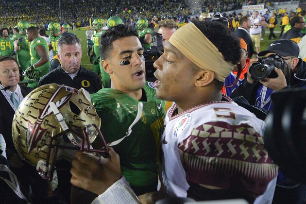 FILE - In this Jan. 1, 2015, file photo, Oregon quarterback Marcus Mariota, center left, greets Florida State quarterback Jameis Winston after Oregon's win in the Rose Bowl NCAA college football playoff semifinal game in Pasadena, Calif. There will be several noticeable absences when the three-day draft starts Thursday night, including potential top picks. Winston, Mariota and Alabama wide receiver Amari Cooper all plan to skip the spotlight.  (AP Photo/Mark J. Terrill, File)