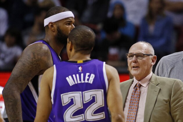 Sacramento Kings head coach George Karl, right, speaks with players Sacramento Kings center DeMarcus Cousins, left, and Andre Miller in the first half of his team's game against the Miami Heat in an NBA basketball game, Saturday, March 7, 2015, in Miami. Miami won the game 114-109. (AP Photo/Joe Skipper)