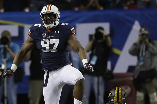 Auburn defensive end Elijah Daniel (97) celebrates sacking Missouri quarterback James Franklin (1) during the second half of the Southeastern Conference NCAA football championship game, Saturday, Dec. 7, 2013, in Atlanta. (AP Photo/John Bazemore)