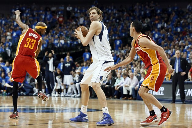 Dallas Mavericks' Dirk Nowitzki (41) of Germany handles the ball as Houston Rockets' Corey Brewer (33) and Pablo Prigioni, right, of Argentina defend in the second half of Game 4 in an NBA basketball first-round playoff series Sunday April 26, 2015, in Dallas. The Mavericks won 121-109. (AP Photo/Tony Gutierrez)