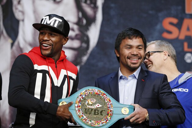 Floyd Mayweather Jr., left, and Manny Pacquiao pose with a WBC belt during a press conference Wednesday, April 29, 2015, in Las Vegas. Mayweather will face Pacquiao in a welterweight boxing match in Las Vegas on May 2. (AP Photo/John Locher)