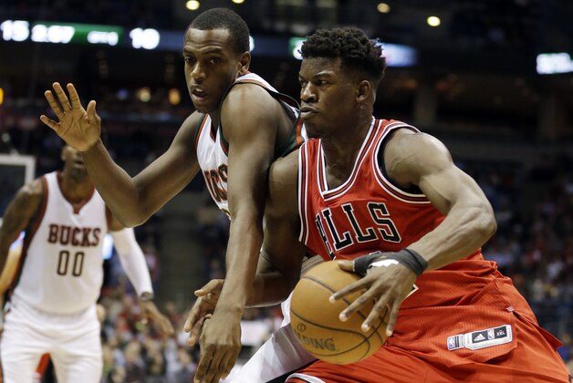 Chicago Bulls' Jimmy Butler tries to drive past Milwaukee Bucks' Khris Middleton during the first half of an NBA basketball game Wednesday, Nov. 5, 2014, in Milwaukee. (AP Photo/Morry Gash)