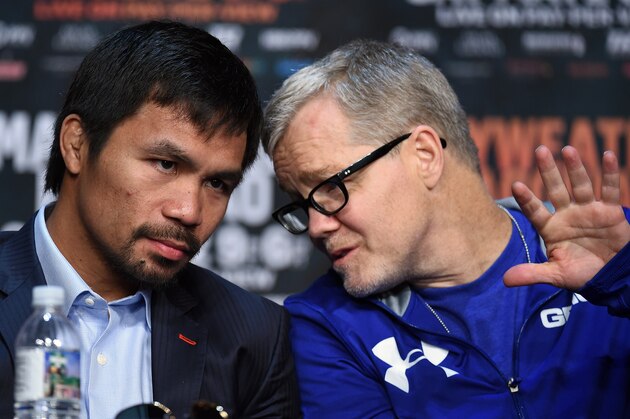 LAS VEGAS, NV - APRIL 29:  WBO welterweight champion Manny Pacquiao (L) talks with his trainer Freddie Roach during a news conference at the KA Theatre at MGM Grand Hotel & Casino on April 29, 2015 in Las Vegas, Nevada. Pacquiao will face WBC/WBA welterweight champion Floyd Mayweather Jr. in a unification bout on May 2, 2015 in Las Vegas.  (Photo by Ethan Miller/Getty Images)
