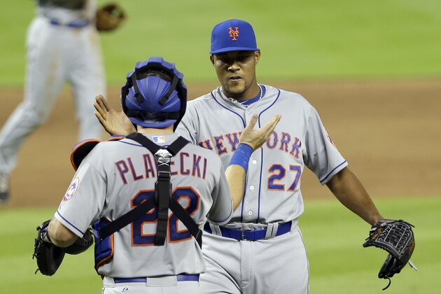 New York Mets relief pitcher Jeurys Familia (27) and catcher Kevin Plawecki (22) celebrate their 3-1 win against the Miami Marlins after a baseball game, Monday, April 27, 2015, in Miami. (AP Photo/Alan Diaz)
