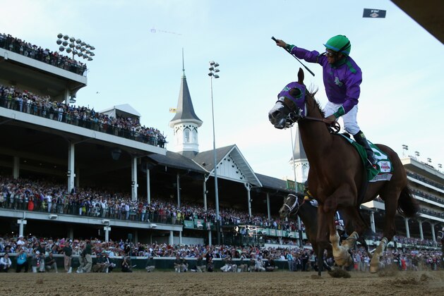 LOUISVILLE, KY - MAY 03:  Jockey Victor Espinoza celebrates atop of California Chrome #5 after crossing the finish line to win the 140th running of the Kentucky Derby at Churchill Downs on May 3, 2014 in Louisville, Kentucky.  (Photo by Matthew Stockman/Getty Images)
